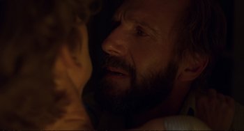 Movie still from “A Bigger Splash” (2015), directed by Luca Guadagnino – A man with a goatee and a beard looking at a woman; Close Up shot, Over the shoulder angle