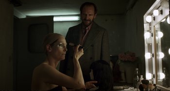Movie still from “A Bigger Splash” (2015), directed by Luca Guadagnino – A man and a woman are in a dark room; Close Up shot, Over the shoulder angle