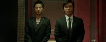 Two men in suits standing next to each other