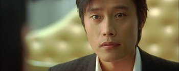 A man's face in a suit and tie