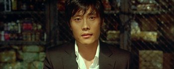 A man in a black suit and a white shirt