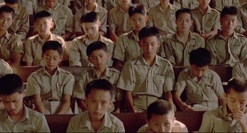 Movie still from “A Brighter Summer Day” (1991), directed by Edward Yang – A group of young men sitting in a row in front of each other; Medium shot, High angle