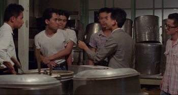 Movie still from “A Brighter Summer Day” (1991), directed by Edward Yang – A group of men standing in front of a wall; Medium shot, Over the shoulder angle