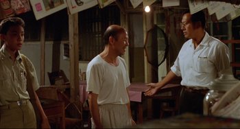 Movie still from “A Brighter Summer Day” (1991), directed by Edward Yang – A man in a white shirt talking to another man in a white shirt; Medium shot, Over the shoulder angle