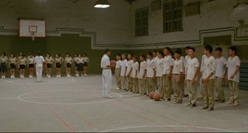 Movie still from “A Brighter Summer Day” (1991), directed by Edward Yang – A group of young men standing in front of each other holding basketballs; Extreme Wide shot, High angle