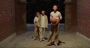Movie still from “A Brighter Summer Day” (1991), directed by Edward Yang – A group of young men standing next to each other; Wide shot, Low angle