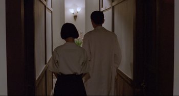 Movie still from “A Brighter Summer Day” (1991), directed by Edward Yang – A man and a woman walking down a long hallway; Medium shot, Low angle
