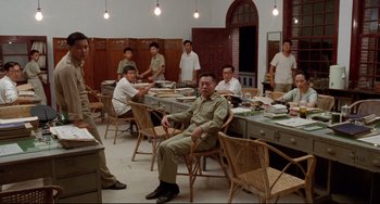 Movie still from “A Brighter Summer Day” (1991), directed by Edward Yang – A group of men sitting around a table in a room; Wide shot, High angle