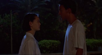 Movie still from “A Brighter Summer Day” (1991), directed by Edward Yang – A man and a woman standing next to each other in the dark; Medium shot, Over the shoulder angle