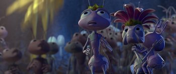 Movie still from “A Bug's Life” (1998), directed by John Lasseter – An animated bug is standing in front of a group of other bugs; Close Up shot, High angle