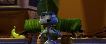 Movie still from “A Bug's Life” (1998), directed by John Lasseter – A cartoon of a blue creature with a leaf on it's head; Extreme Close Up shot, Low angle