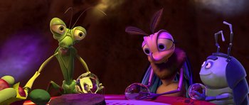 Movie still from “A Bug's Life” (1998), directed by John Lasseter – An image of a cartoon character that is sitting in front of a cake; Close Up shot, Over the shoulder angle