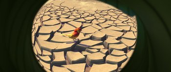Movie still from “A Bug's Life” (1998), directed by John Lasseter – A bird is sitting on the cracked ground; Extreme Wide shot, High angle