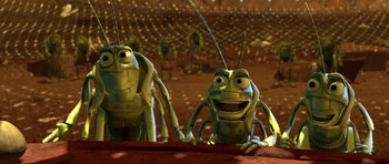Movie still from “A Bug's Life” (1998), directed by John Lasseter – A couple of green bugs sitting next to each other; Medium shot, High angle
