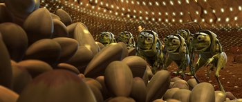 Movie still from “A Bug's Life” (1998), directed by John Lasseter – A group of bees that are standing in a pile of nuts; Extreme Wide shot, High angle