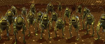 Movie still from “A Bug's Life” (1998), directed by John Lasseter – A bunch of green bugs are standing in the dirt; Extreme Wide shot, High angle
