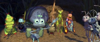 Movie still from “A Bug's Life” (1998), directed by John Lasseter – An animated bug is holding his arms out; Wide shot, High angle