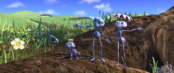 Movie still from “A Bug's Life” (1998), directed by John Lasseter – A group of people standing next to each other on a dirt hill; Wide shot, High angle
