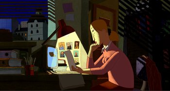 Movie still from “A Cat in Paris” (2010), directed by Alain Gagnol – A woman sitting in front of a computer looking at pictures; Wide shot, High angle