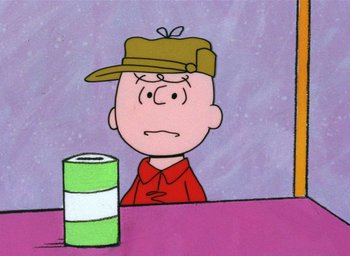 Movie still from “A Charlie Brown Christmas” (1965), directed by Bill Melendez – A drawing of charlie brown sitting in front of a roll of toilet paper; Close Up shot, Overhead angle