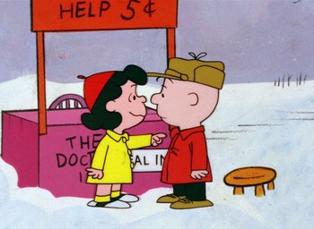 Movie still from “A Charlie Brown Christmas” (1965), directed by Bill Melendez – A charlie brown and a lucy kiss in front of a building; Extreme Wide shot, High angle