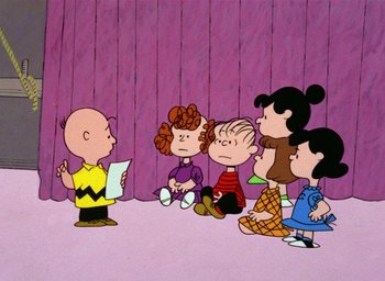 Movie still from “A Charlie Brown Christmas” (1965), directed by Bill Melendez – A group of people sitting in front of charlie brown; Extreme Wide shot, High angle