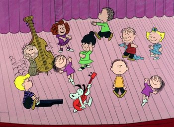 Movie still from “A Charlie Brown Christmas” (1965), directed by Bill Melendez – A group of people standing on top of a wooden floor; Extreme Wide shot, High angle