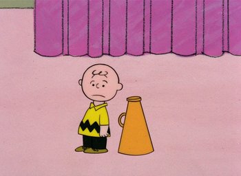 Movie still from “A Charlie Brown Christmas” (1965), directed by Bill Melendez – A charlie brown character standing in front of an orange cone; Extreme Wide shot, High angle