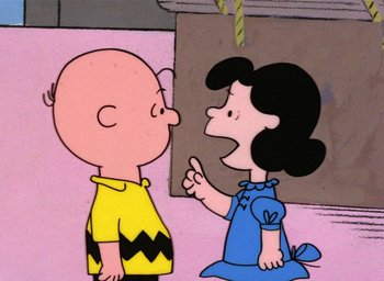 Movie still from “A Charlie Brown Christmas” (1965), directed by Bill Melendez – A charlie brown and a lucy cartoon character talking to each other; Medium shot, High angle