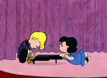 Movie still from “A Charlie Brown Christmas” (1965), directed by Bill Melendez – A couple of people that are sitting on the ground; Extreme Wide shot, High angle