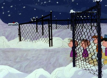 Movie still from “A Charlie Brown Christmas” (1965), directed by Bill Melendez – A girl looking through a chain link fence at night; Extreme Wide shot, High angle