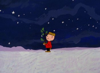Movie still from “A Charlie Brown Christmas” (1965), directed by Bill Melendez – Charlie brown holding a christmas tree while standing in the snow at night; Extreme Wide shot, Low angle