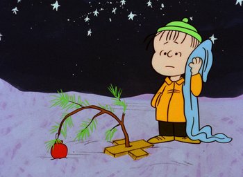 Movie still from “A Charlie Brown Christmas” (1965), directed by Bill Melendez – A charlie brown cartoon character standing next to an apple tree; Extreme Wide shot, High angle