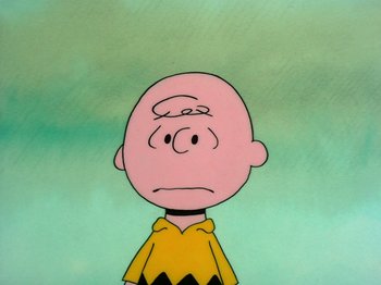 Movie still from “A Charlie Brown Thanksgiving” (1973), directed by Phil Roman – A charlie brown cartoon character with a sad look on his face; Close Up shot, High angle