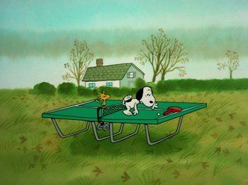 Movie still from “A Charlie Brown Thanksgiving” (1973), directed by Phil Roman – A dog is sitting on top of a green trampoline; Extreme Wide shot, High angle