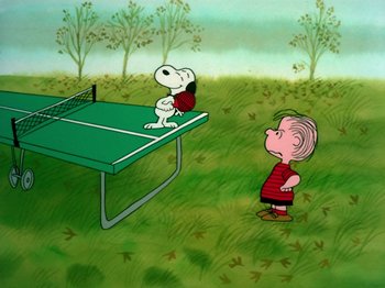 Movie still from “A Charlie Brown Thanksgiving” (1973), directed by Phil Roman – A cartoon of a boy and a dog playing a game of ping pong; Extreme Wide shot, High angle