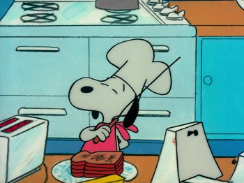 Movie still from “A Charlie Brown Thanksgiving” (1973), directed by Phil Roman – A painting of a dog in a kitchen with food; Extreme Wide shot, Overhead angle
