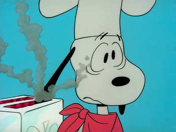 Movie still from “A Charlie Brown Thanksgiving” (1973), directed by Phil Roman – A cartoon of a dog smoking a cigarette in front of a cake; Close Up shot, Low angle