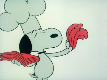 Movie still from “A Charlie Brown Thanksgiving” (1973), directed by Phil Roman – A cartoon picture of a dog holding a bunch of food; Extreme Close Up shot, High angle