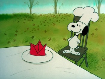 Movie still from “A Charlie Brown Thanksgiving” (1973), directed by Phil Roman – A painting of snoopy sitting in front of a paper hat; Close Up shot, High angle