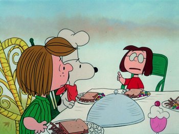 Movie still from “A Charlie Brown Thanksgiving” (1973), directed by Phil Roman – A group of people sitting at a table with plates of food on it; Extreme Wide shot, High angle