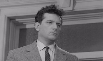 Movie still from “A Child Is Waiting” (1963), directed by John Cassavetes – Black and white photograph of a man wearing a suit and tie; Close Up shot, Low angle