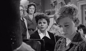 Movie still from “A Child Is Waiting” (1963), directed by John Cassavetes – A black and white photo of a group of people; Medium shot, Over the shoulder angle