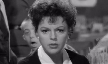 Movie still from “A Child Is Waiting” (1963), directed by John Cassavetes – An old photo of a woman and a man; Close Up shot, Over the shoulder angle