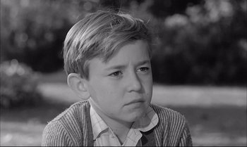 Movie still from “A Child Is Waiting” (1963), directed by John Cassavetes – A young boy is looking at the camera; Close Up shot, High angle