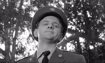 Movie still from “A Child Is Waiting” (1963), directed by John Cassavetes – A man wearing a hat and a uniform looking up; Close Up shot, Low angle