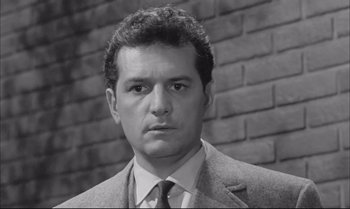 Movie still from “A Child Is Waiting” (1963), directed by John Cassavetes – Black and white photograph of a man wearing a suit; Close Up shot, Low angle