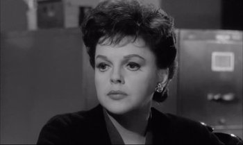 Movie still from “A Child Is Waiting” (1963), directed by John Cassavetes – An old photo of an older woman in a black jacket; Close Up shot, Low angle