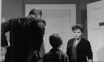 Movie still from “A Child Is Waiting” (1963), directed by John Cassavetes – A man and a woman standing next to a boy; Medium shot, Over the shoulder angle