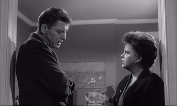 Movie still from “A Child Is Waiting” (1963), directed by John Cassavetes – A man and a woman standing next to each other in a room; Medium shot, Over the shoulder angle